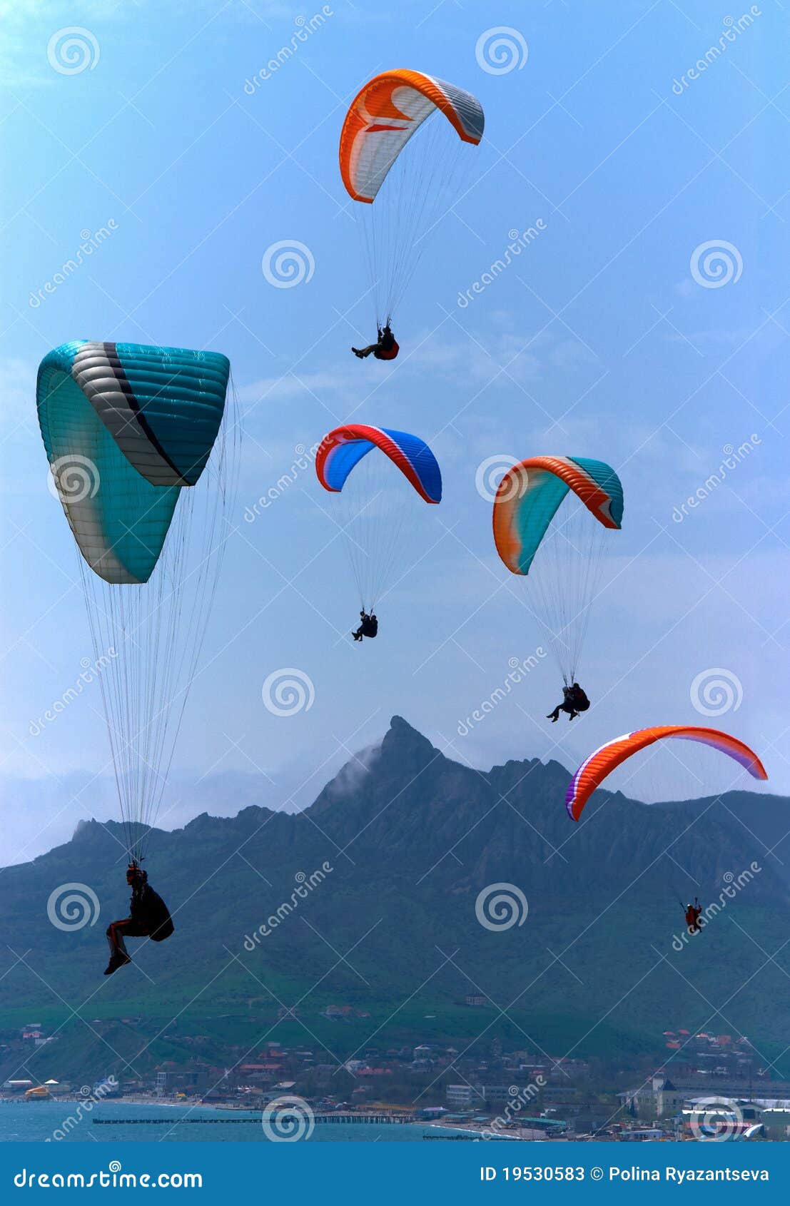 para gliders soaring over the mountains