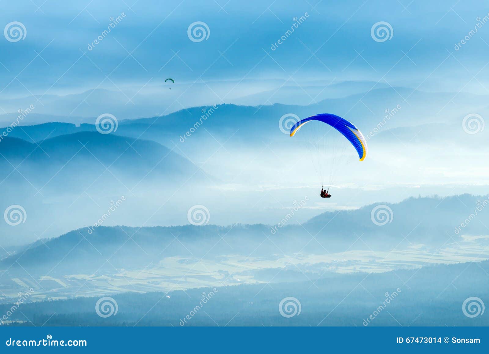 Paraglider Flying Over the Clouds into the Sun Stock Photo Image of