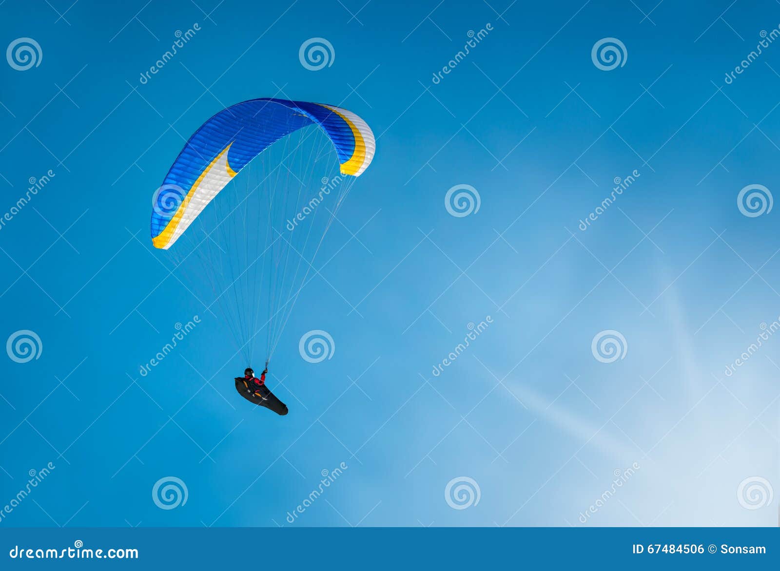 Paraglider Flying Over the Clouds into the Sun Stock Photo Image of