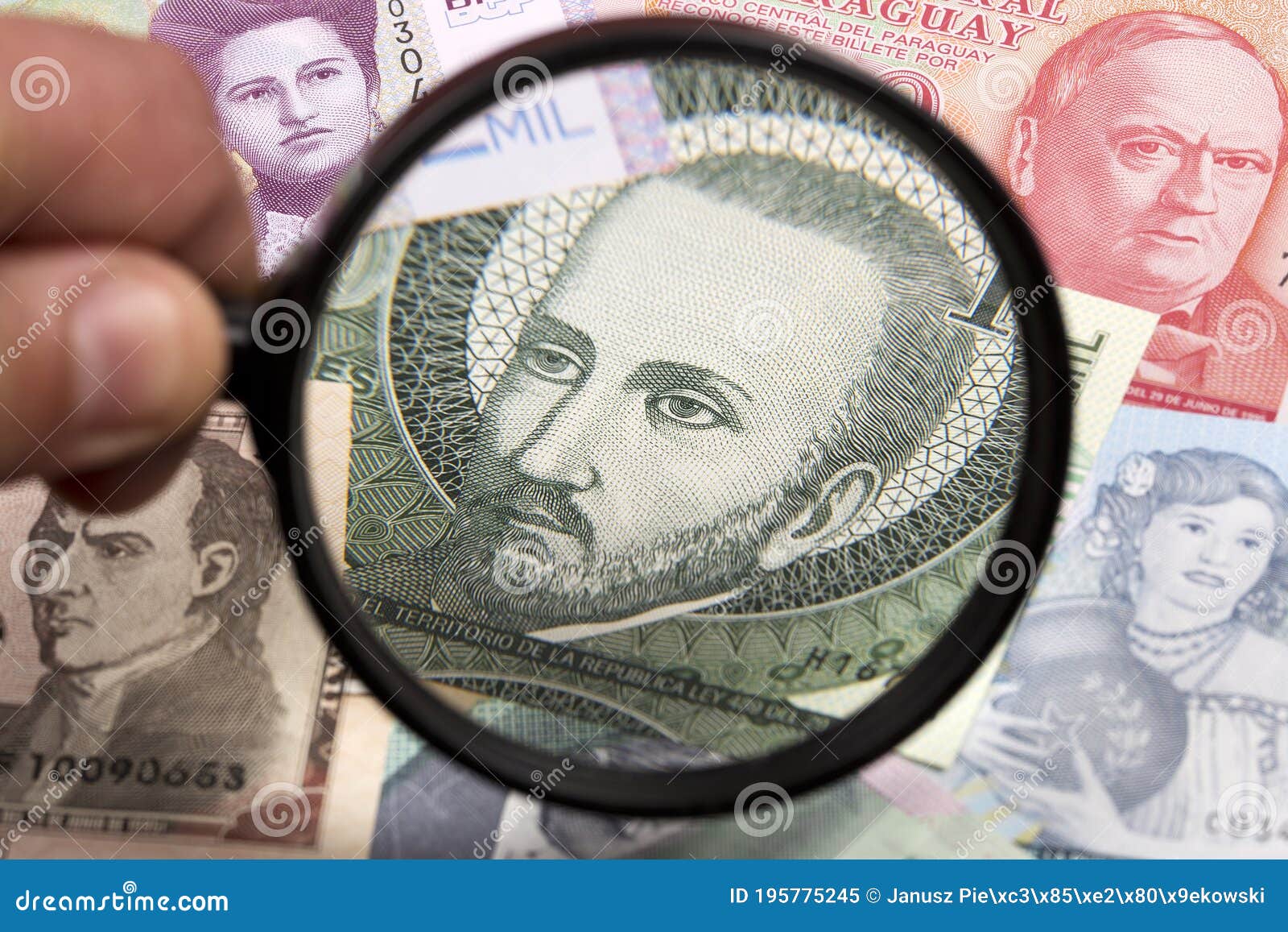 paraguayan money in a magnifying glass