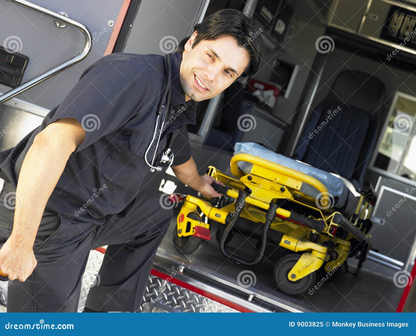 Paramedic Removing Gurney from Ambulance Stock Image Image of