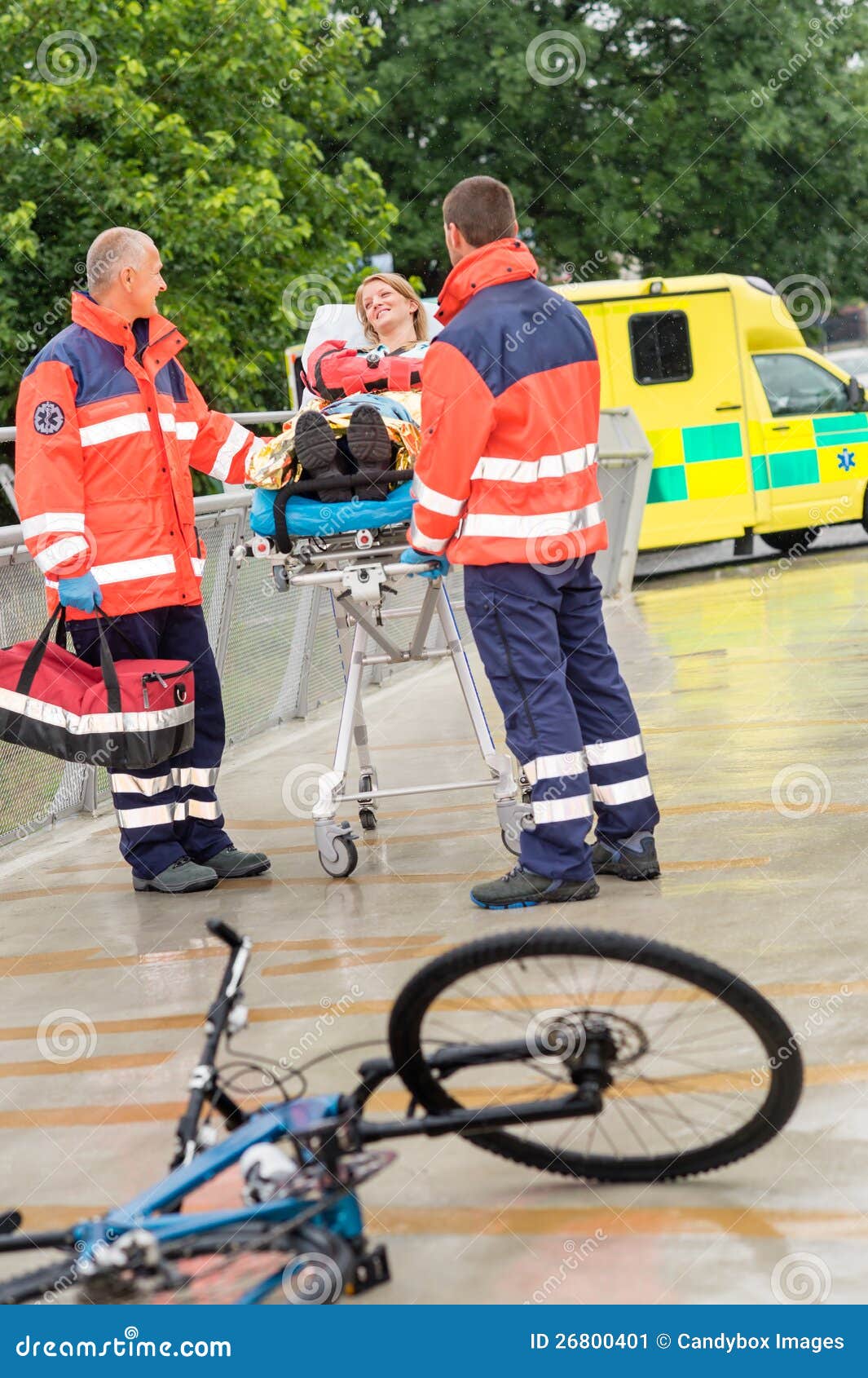 paramedics with woman on stretcher ambulance aid