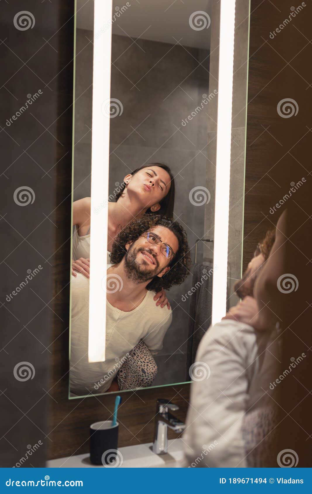 Pareja Haciendo Caras Graciosas Frente Al Espejo Del Baño Foto de archivo -  Imagen de persona, casero: 189671494