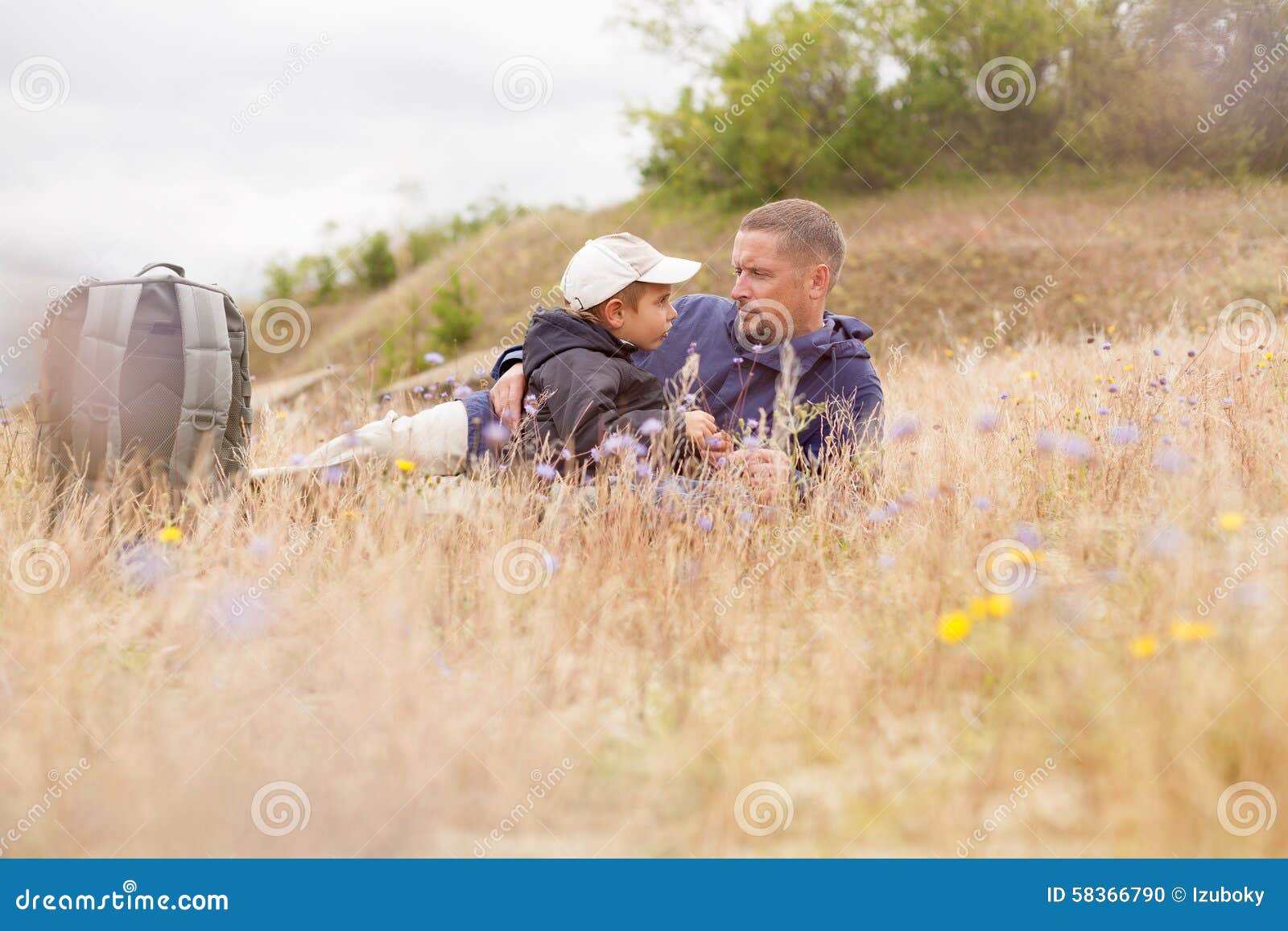 parent talking child nature lying grass meadow