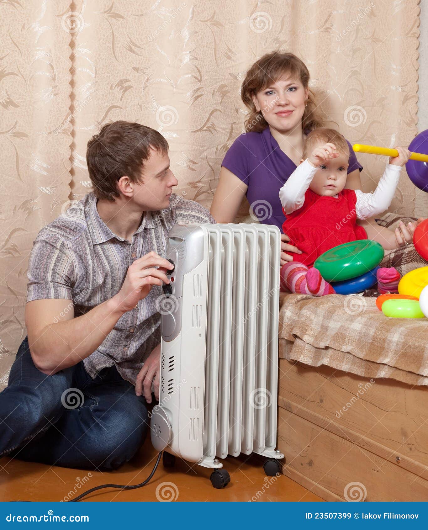 Excited baby boy playing with thermostat of heater Stock Photo - Alamy