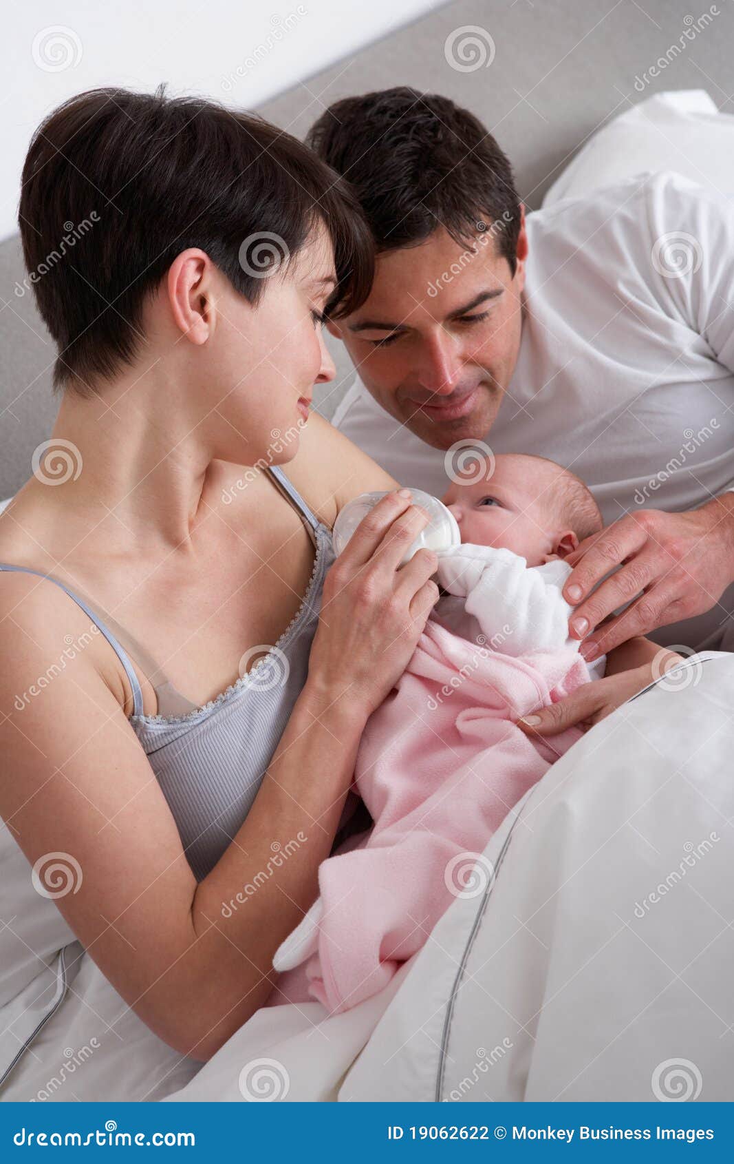 Parents Feeding Newborn Baby In Bed Stock Photography Image 19062622