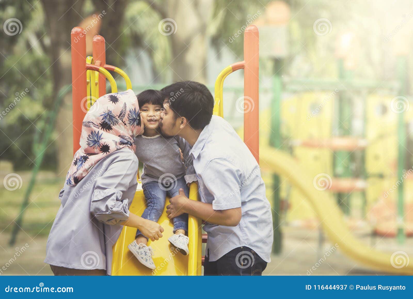 Parents Kissing Their Daughter in the Playground Stock Image - Image of  outdoor, muslim: 116444937