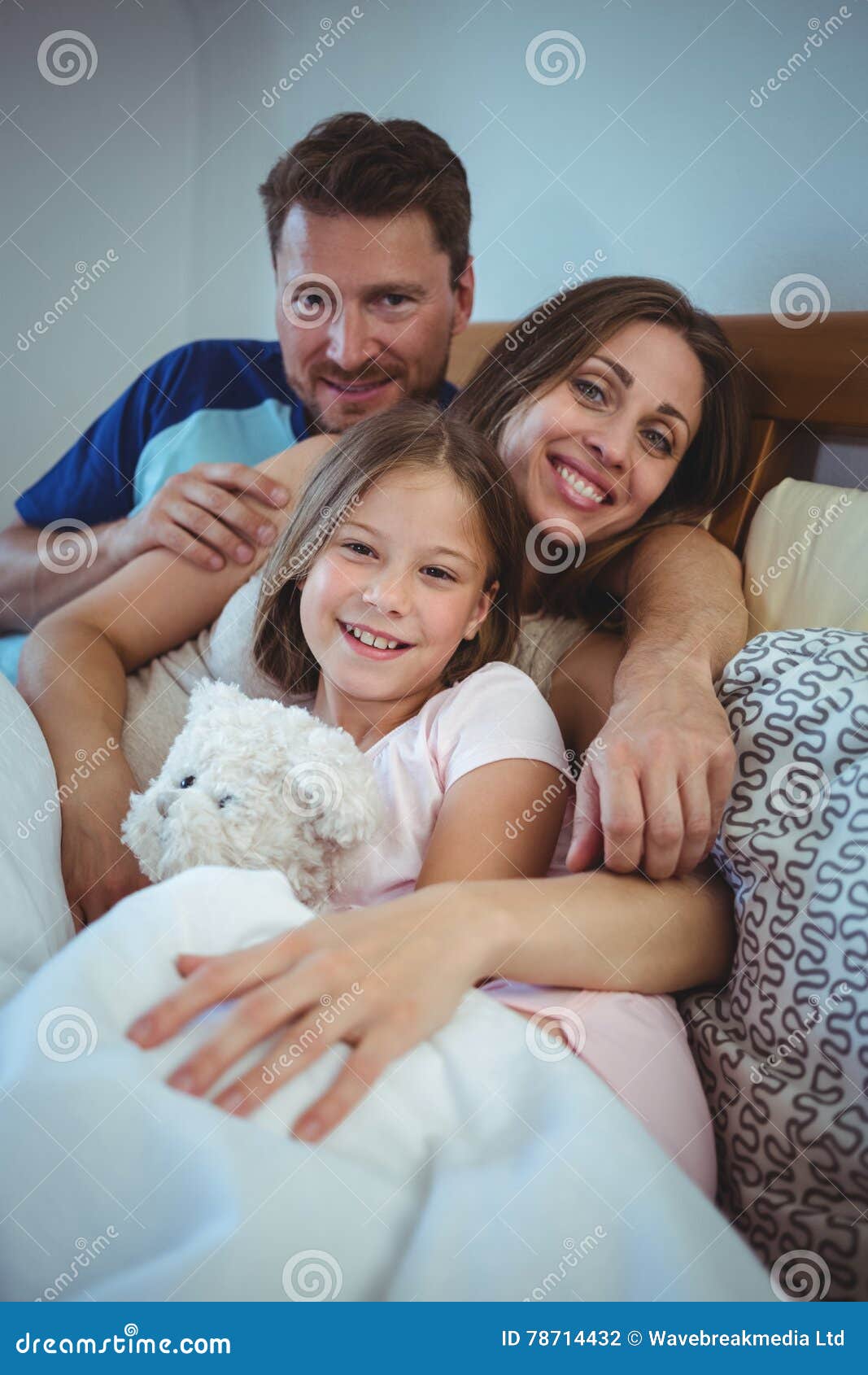 Parents Lying on Bed with Daughter Stock Photo Image of daughter