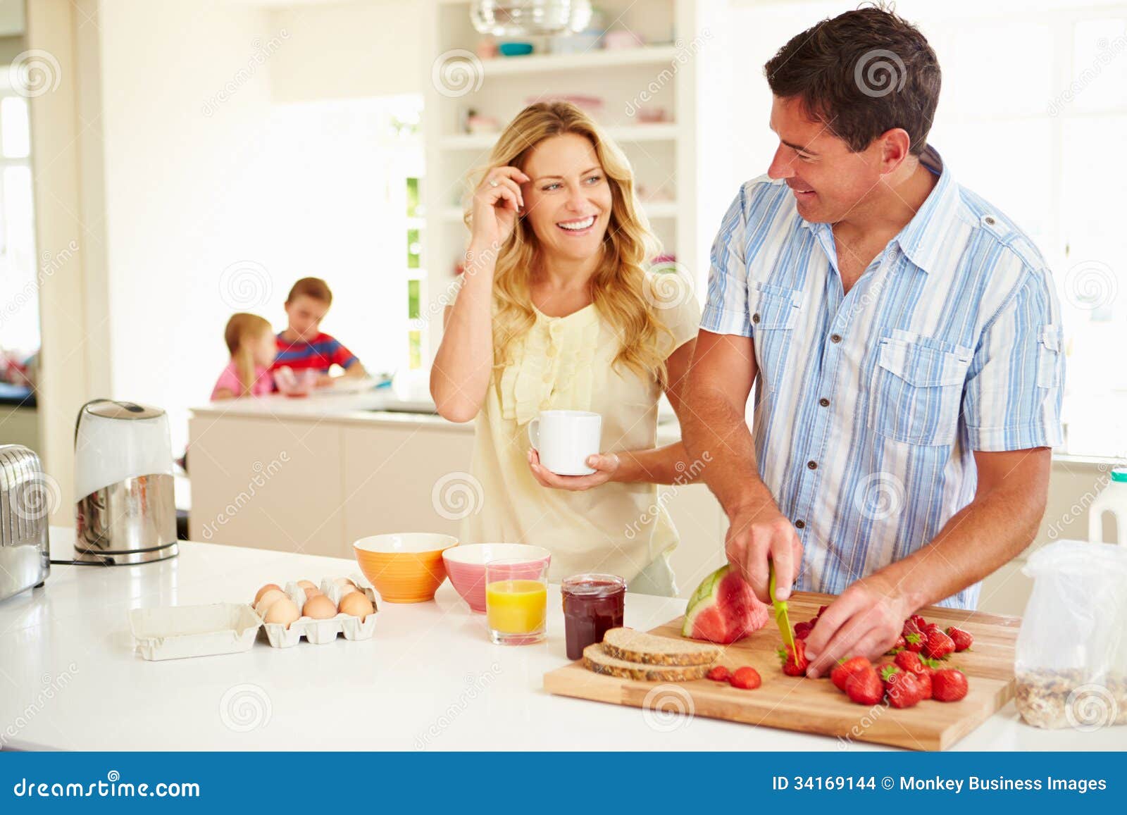 parents preparing family breakfast in kitchen