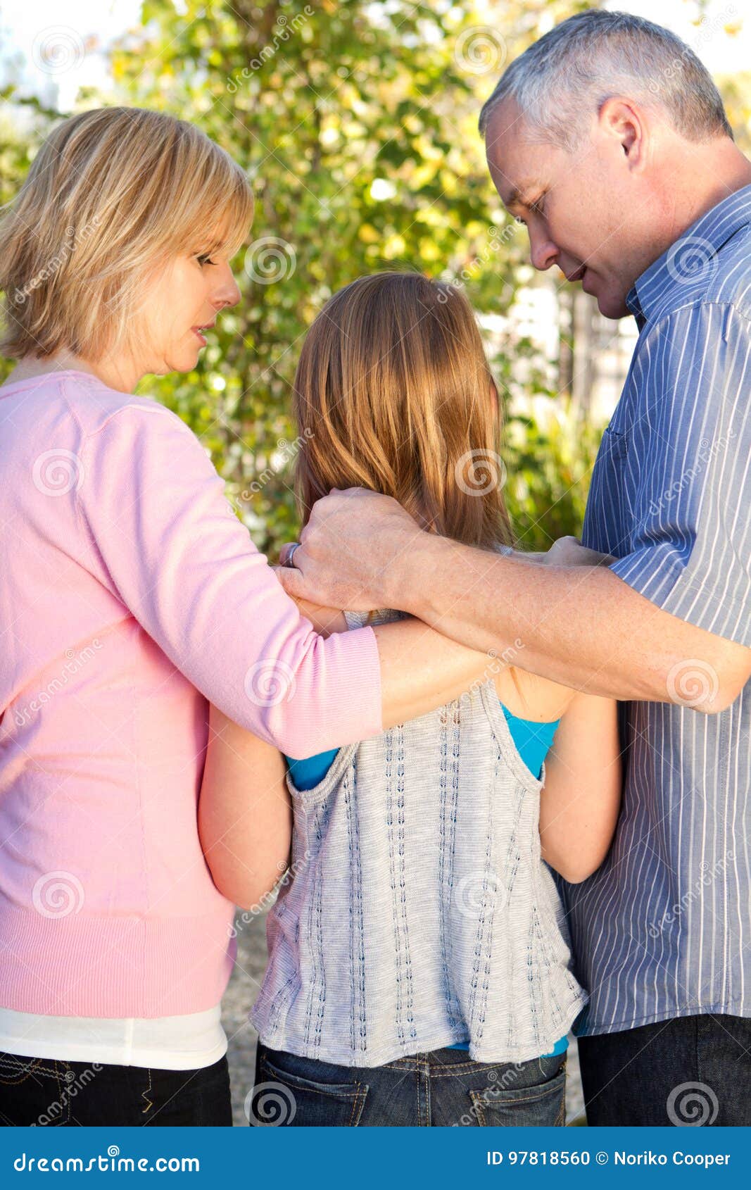 Parents Talking With Their Teenage Daughter. Stock Photo
