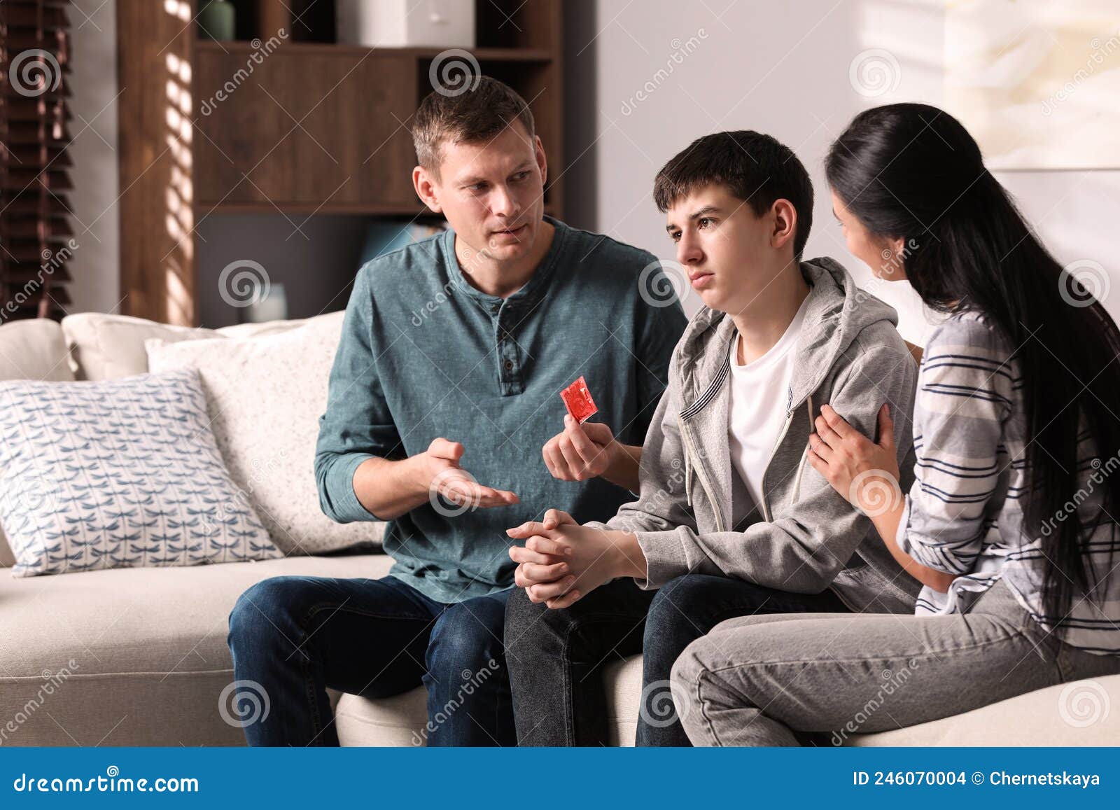 Parents Talking with Their Teenage Son about Contraception at Home photo