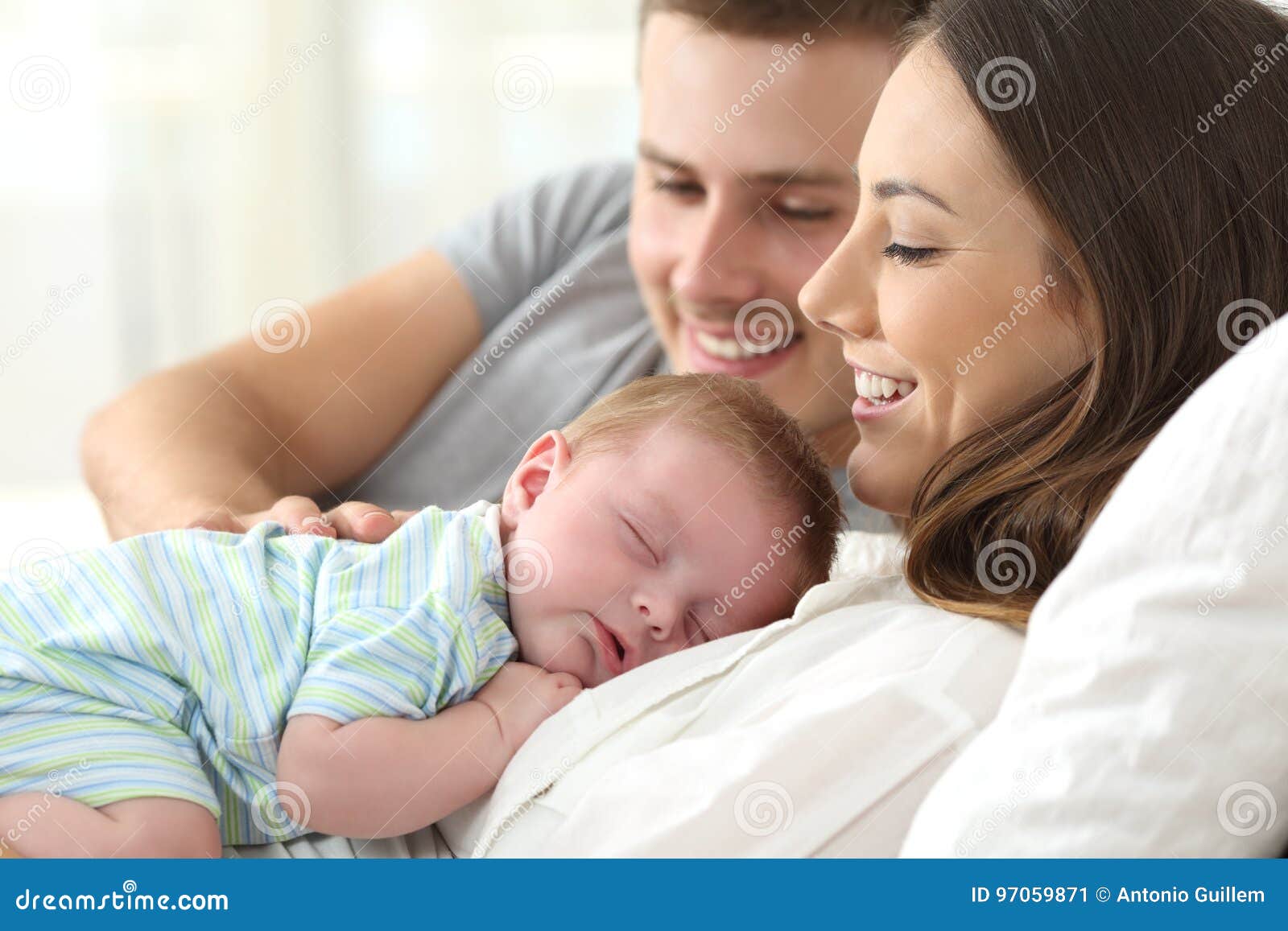 parents watching their baby sleeping