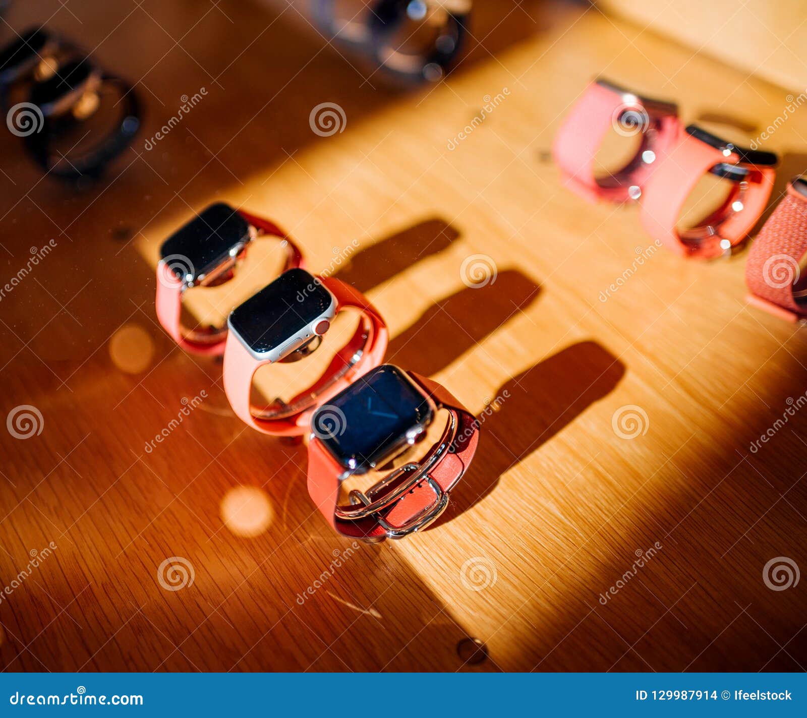 New Apple Watch Series 4 red band. PARIS, FRANCE - OCT 26, 2018: Hero object of the latest Apple Watch Series 4 in Apple Store Computers rows of red bands and aluminum, steel and gold watches