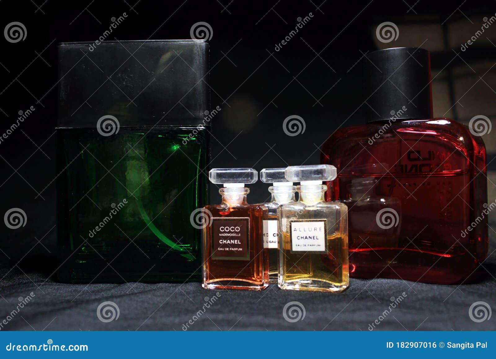 Chanel Perfume & Wild Stone Bottles Isolated on Black Background