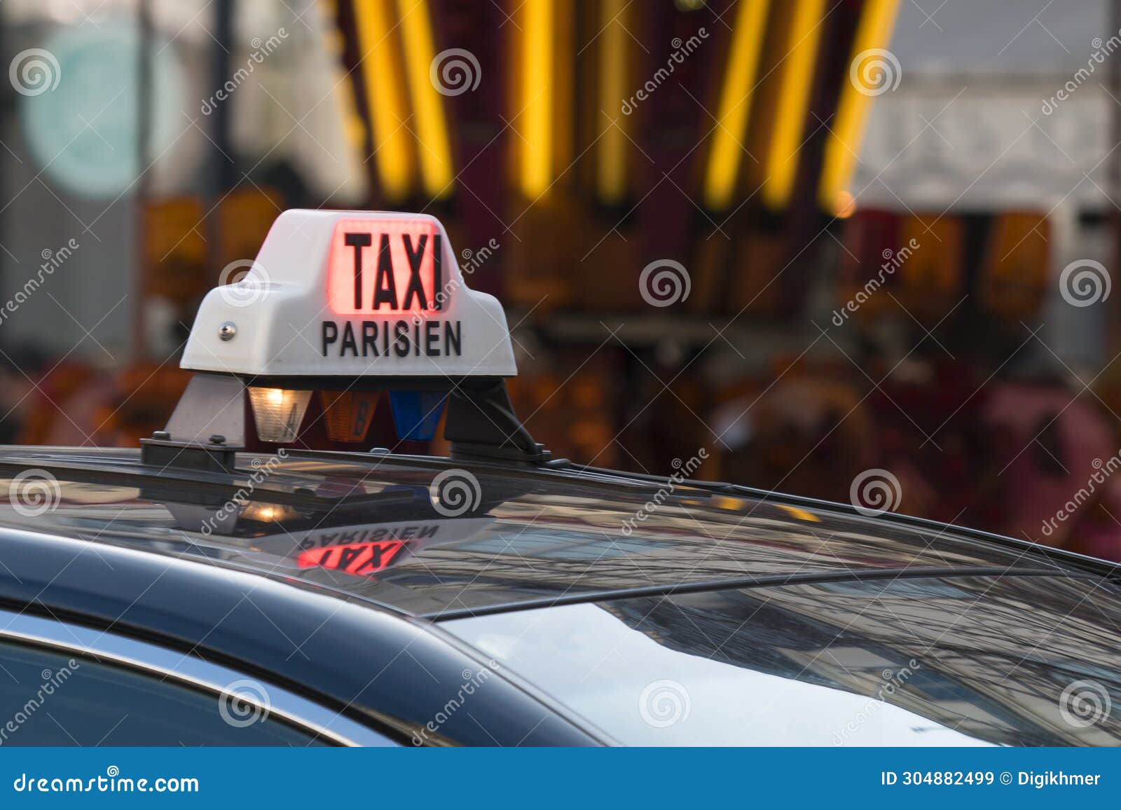 parisian taxi sign and car circulating with customer in the paris streets