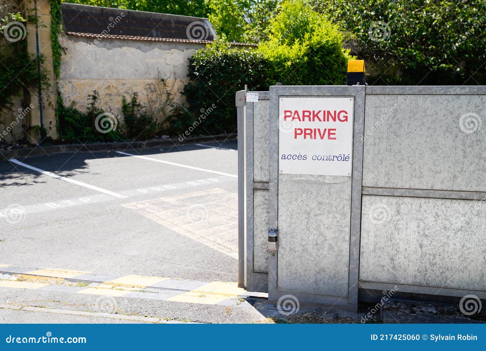 parking prive sign text in french door steel portal open means parking private forbidden acces sign
