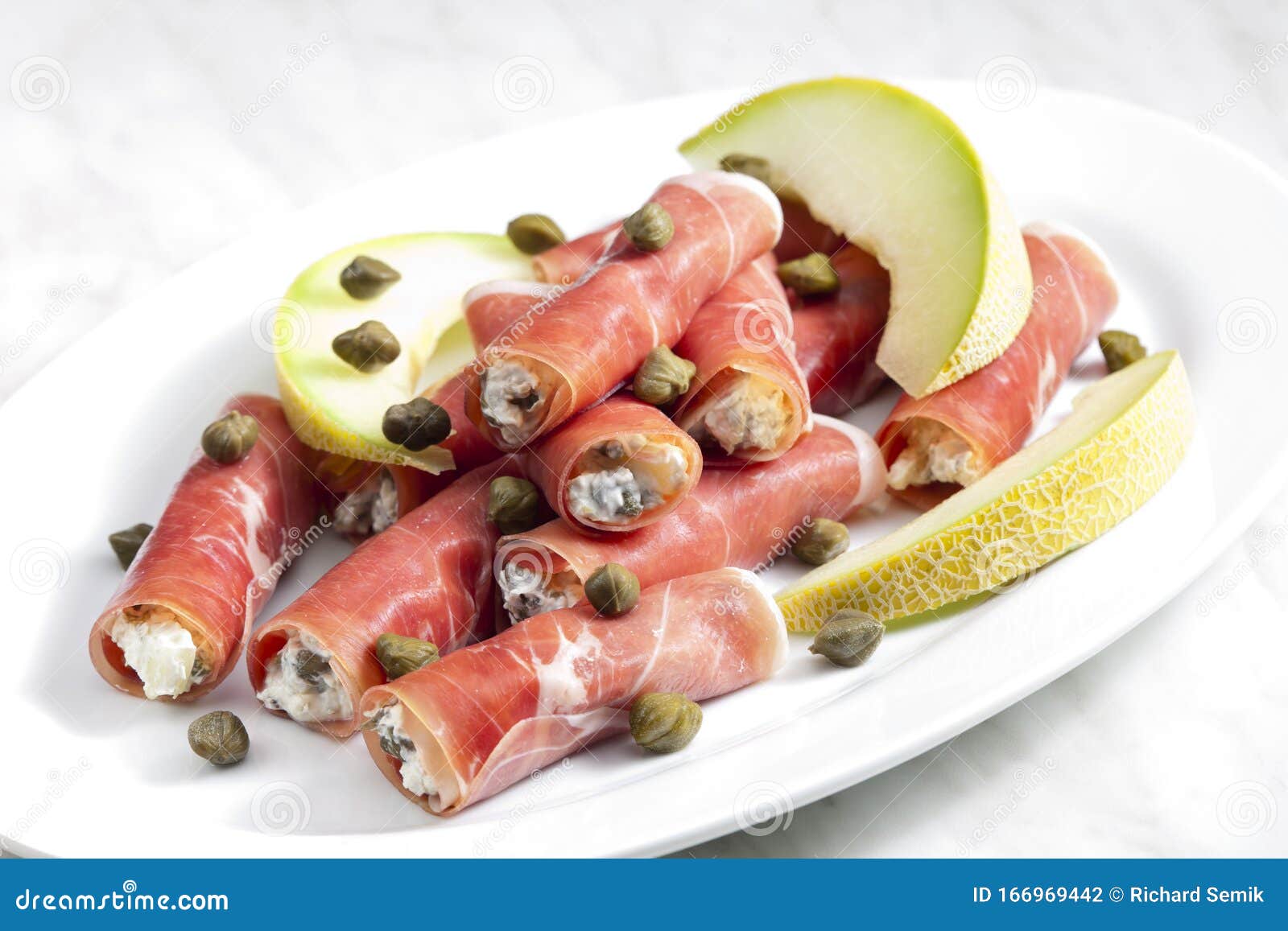 Parma Ham Rolls Filled with Cream Cheese, Galia Melon and Capers Stock