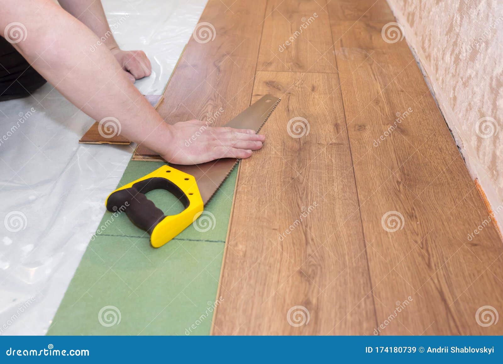 Parquet Board and Hands of the Worker. Repair Floor Work with a