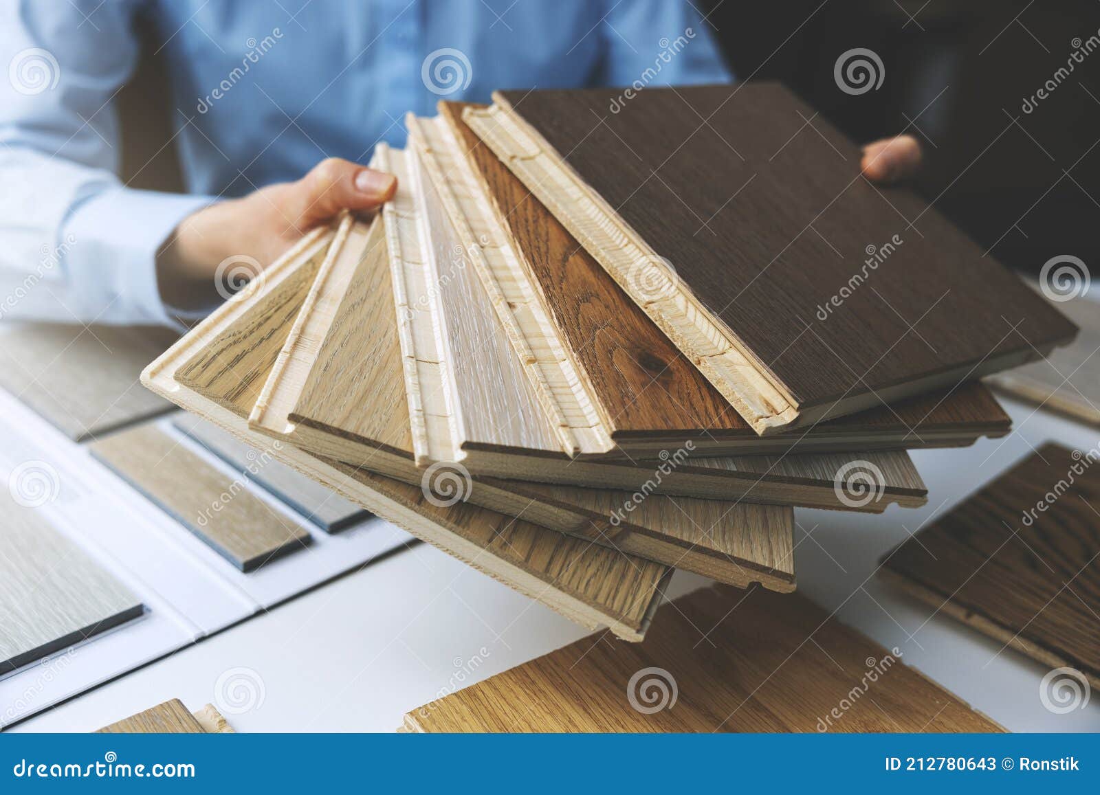 parquet floor - store salesman with flooring samples in hands