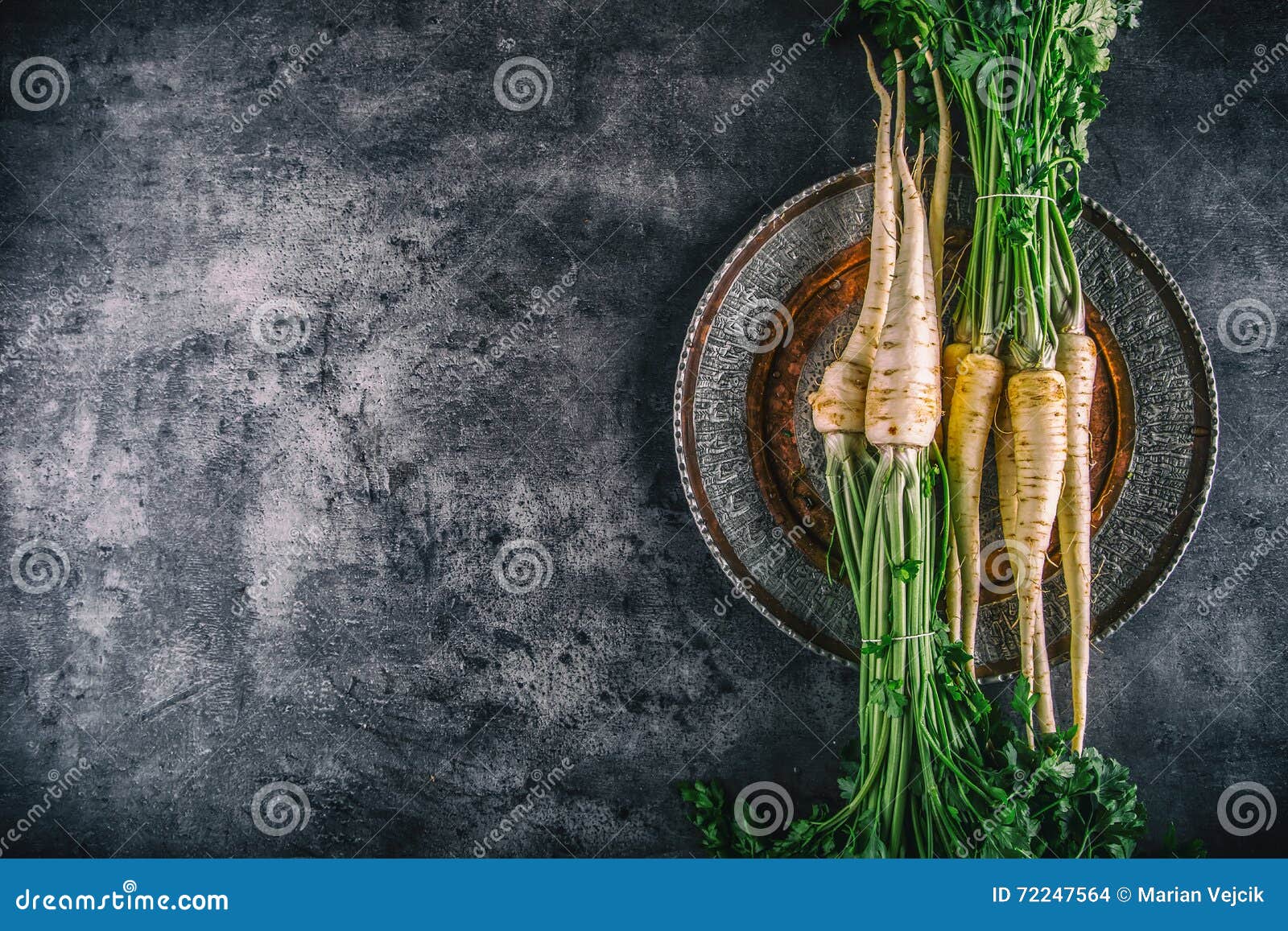 Parsnip. Fresh Parsnip. Parsnip with Parsley on Concrete Board. Several