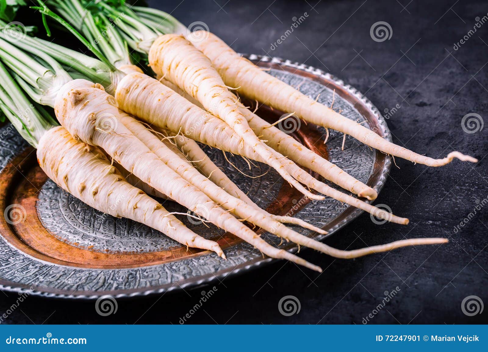 Parsnip. Fresh Parsnip. Parsnip with Parsley on Concrete Board. Several Fresh Parsnip Pieces