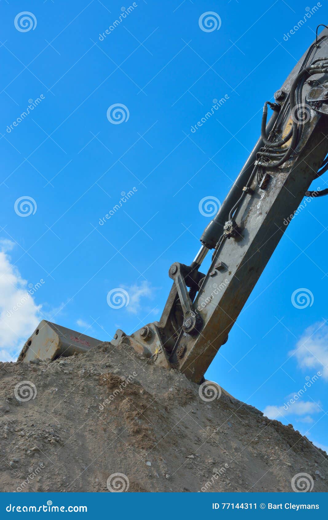 part of a bulldozer sticking in the sand