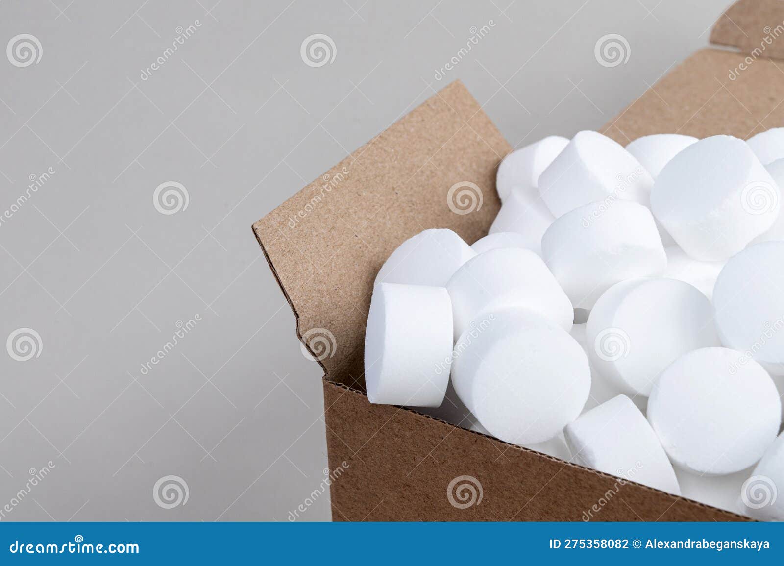 Part of an Open Box with Pressed Dishwasher Salt Top View Stock Photo