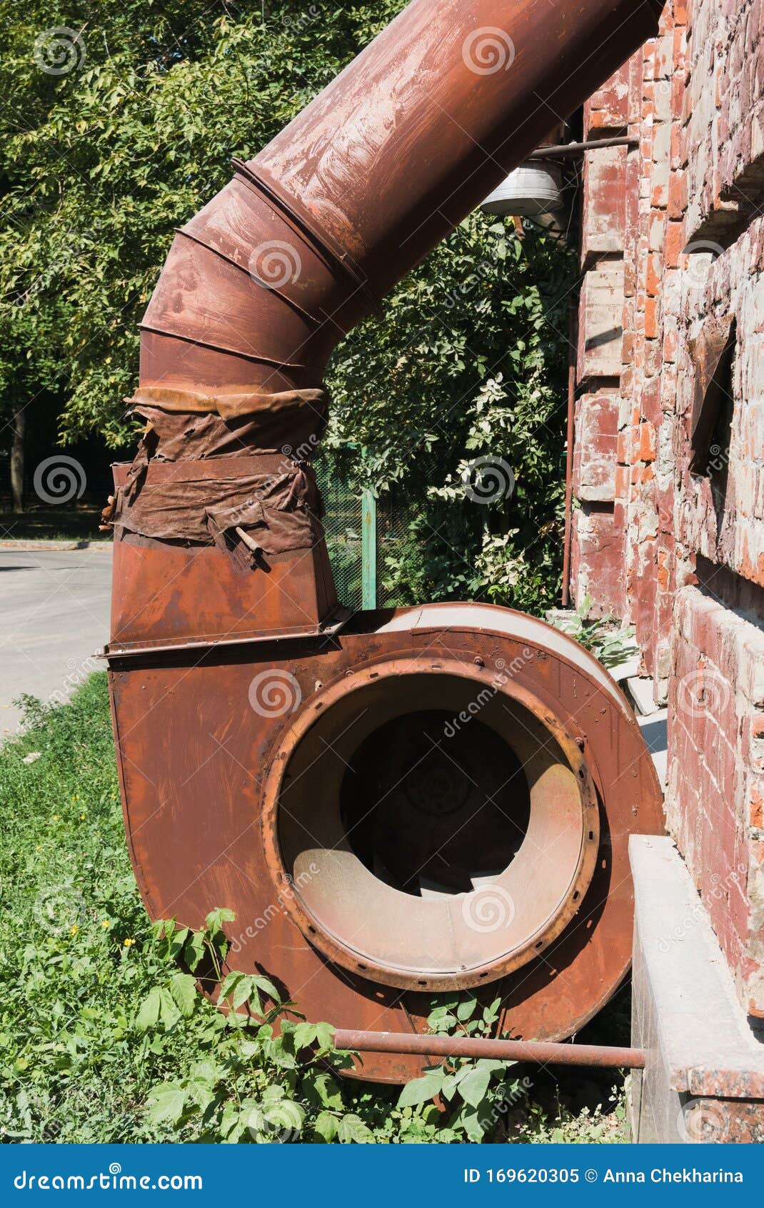 Part of a Retro Ventilation System Outside an Old Brick Building. Rusty Metal of an Old