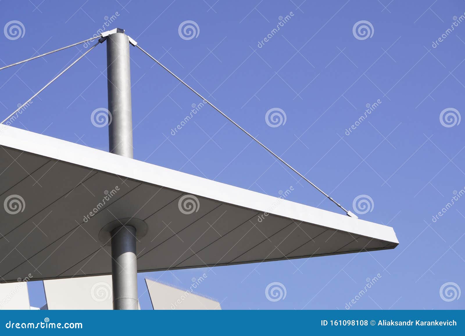 Part of the Roof on the Support and Cables Against the Blue Sky. Modern