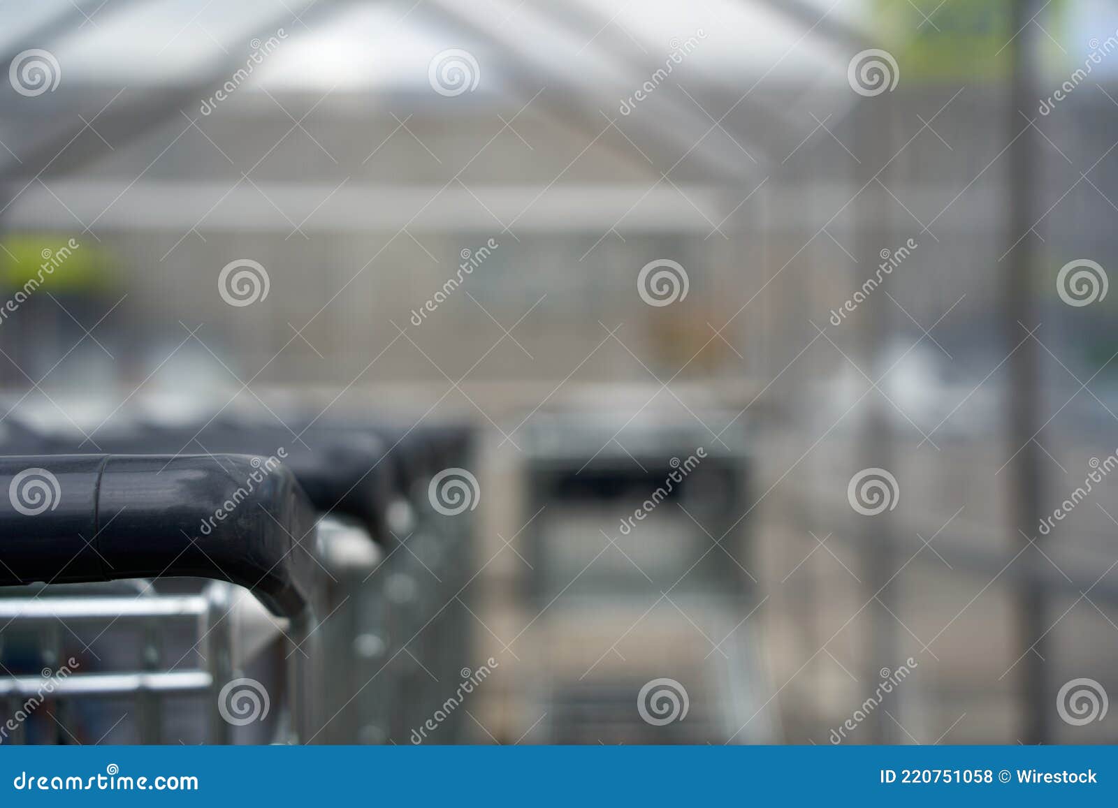 part of a shopping cart with black handle. t