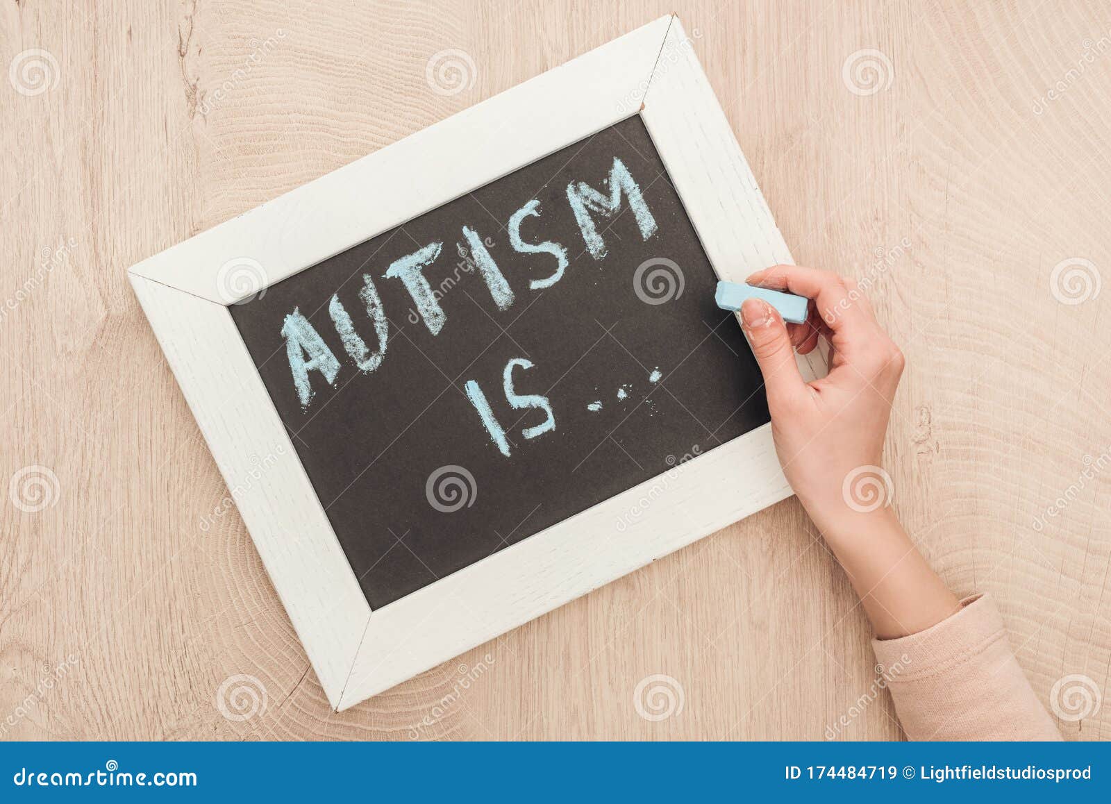 Partial View Of Woman Writing Autism Is Lettering With Chalk On