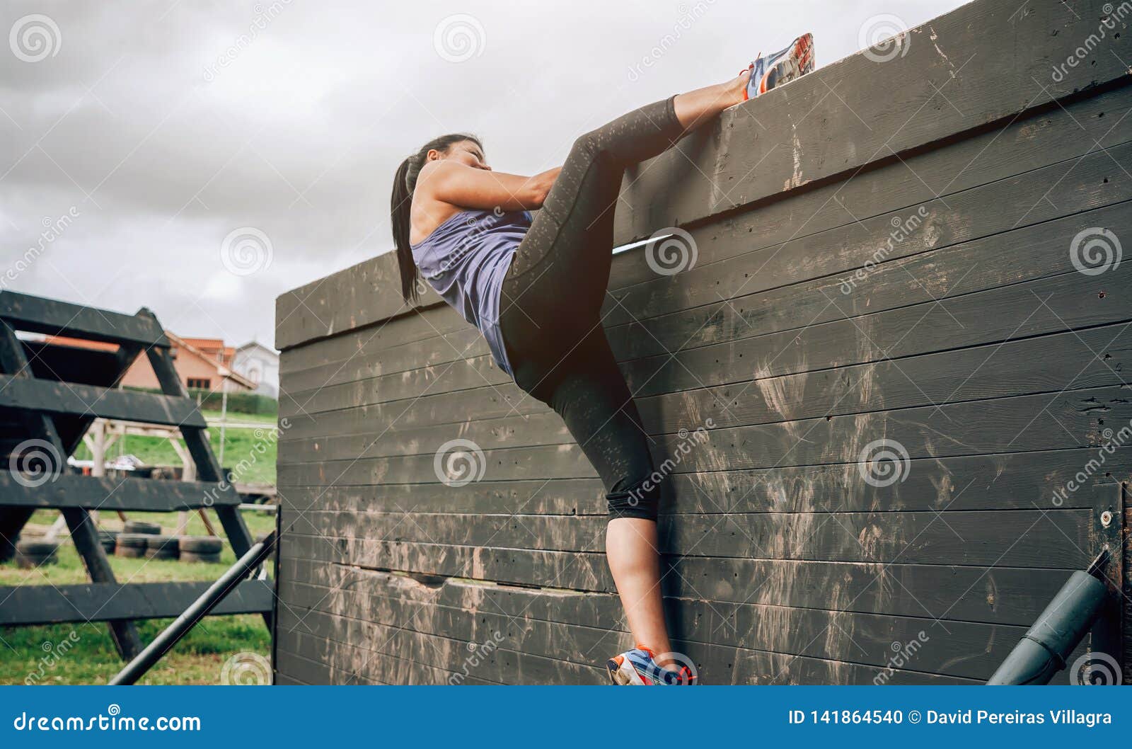 participant in obstacle course climbing wall