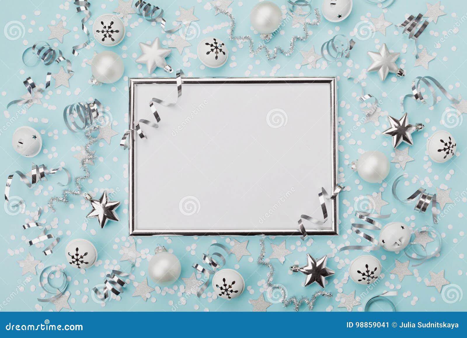 Party carnival christmas background decorated silver frame with confetti balls and star on turquoise desk top view Flat lay Holiday mockup invitation