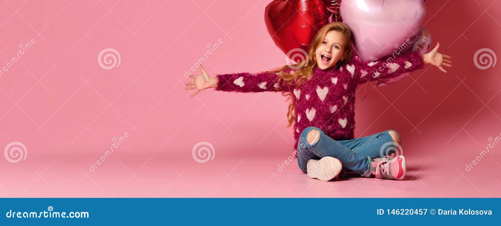 Party girl, balloons, having fun. Birthday party. Happy girl. A little 7 year old girl is sitting on the floor holding a bunch of pink heart-shaped balloons. Celebrates birthday and Valentine`s Day. Hangout. Birthday party.