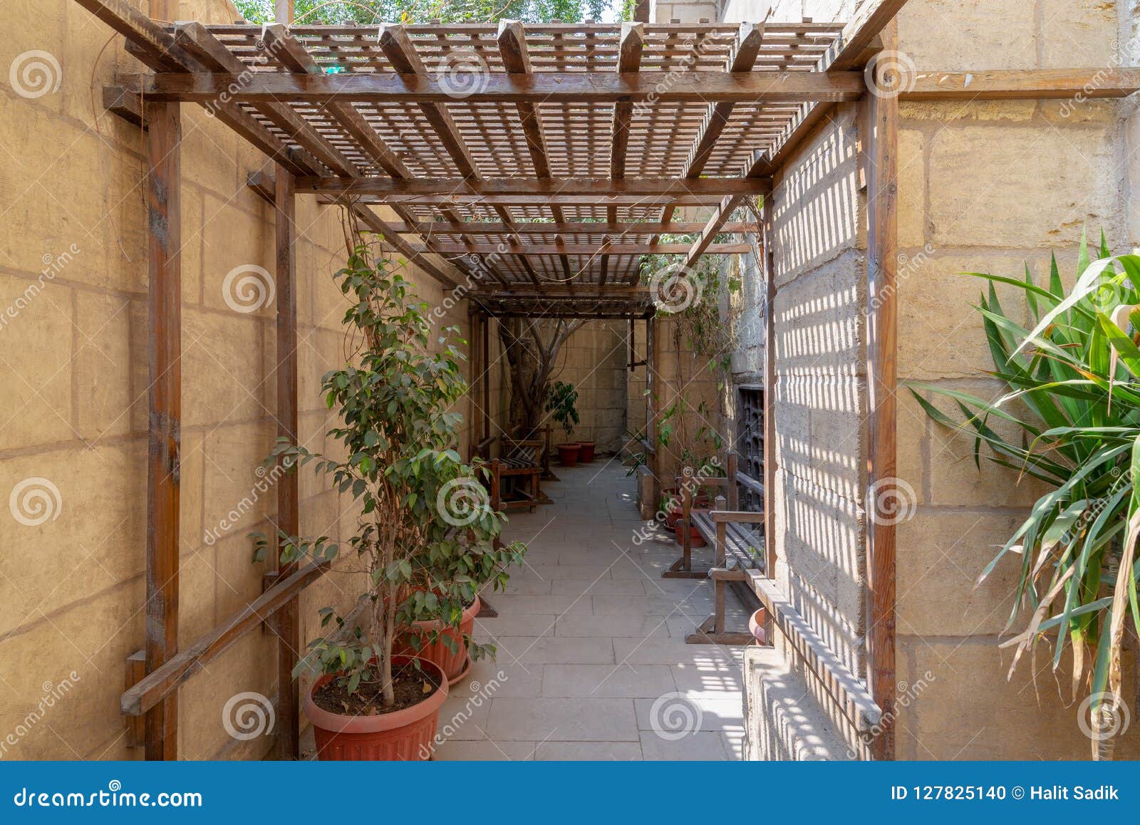 passage ceiled with wooden pergola leading to the historical house of egyptian architecture from the mamluk era, cairo, egypt