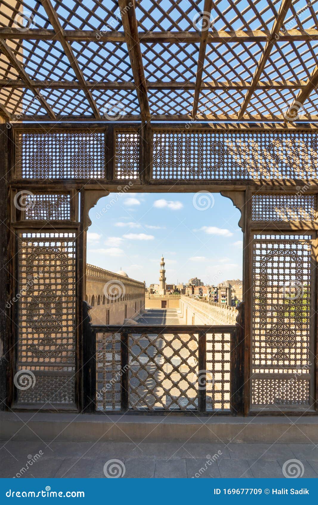 passage surrounding ibn tulun mosque framed by wooden perforated wall - mashrabiya - cairo, egypt