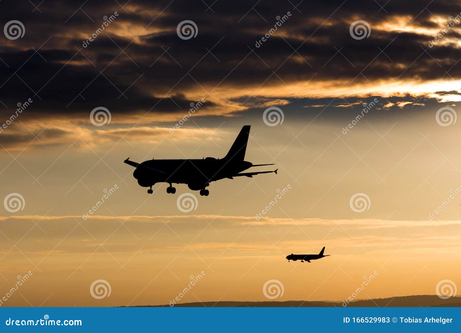 passenger airplanes landing in the evening sun