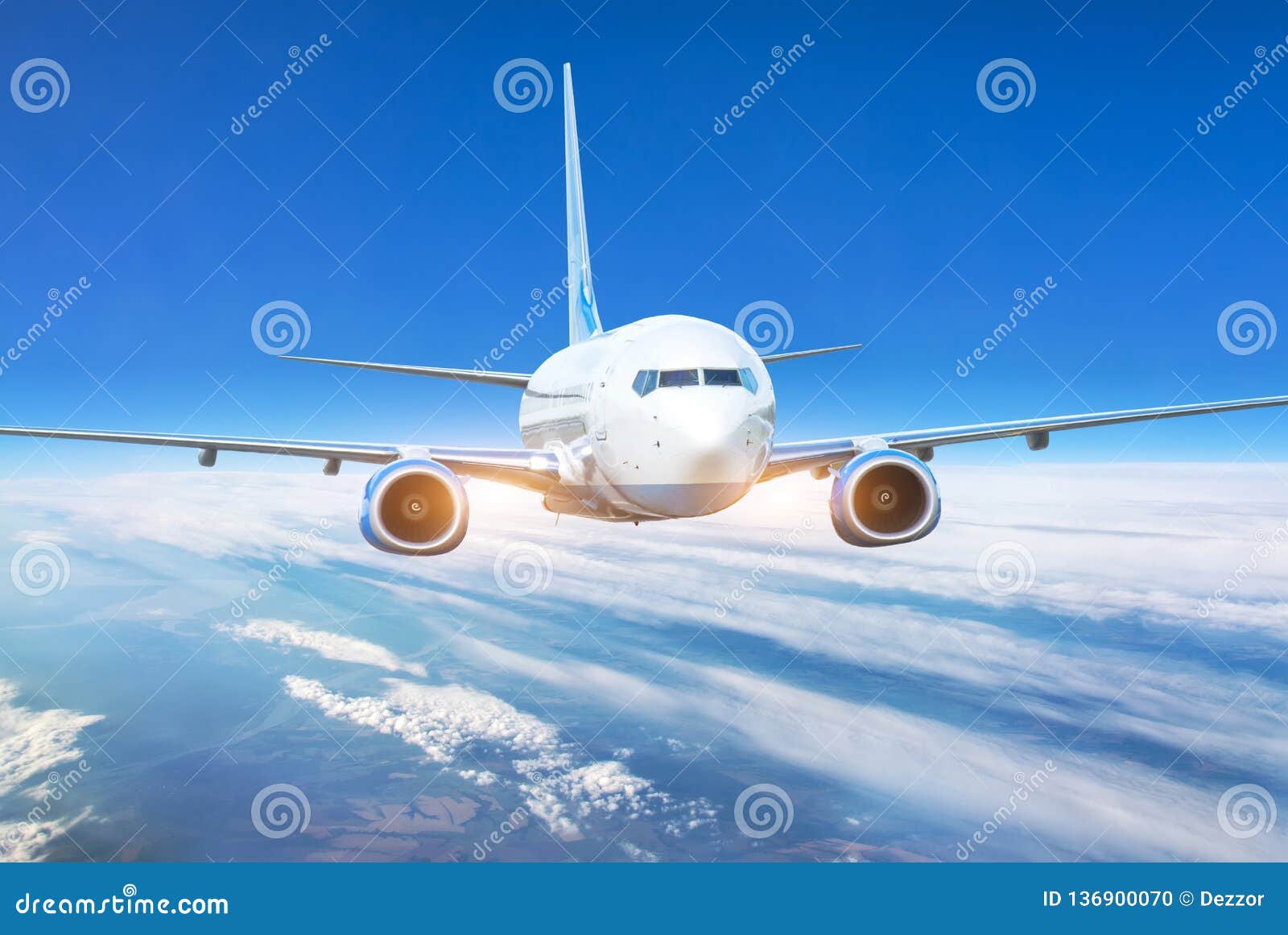 passenger jet plane in the blue sky. aircraft flying high through the cumulus clouds. close up view airplane in flight
