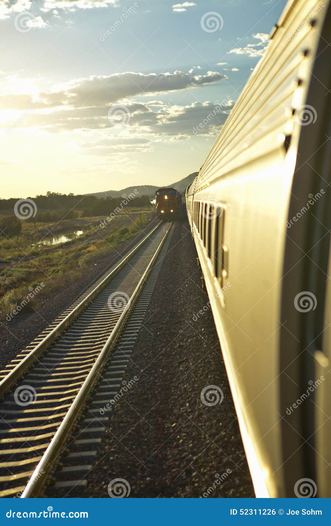 Passenger Train Traveling into the Arizona Sunset Editorial Photo