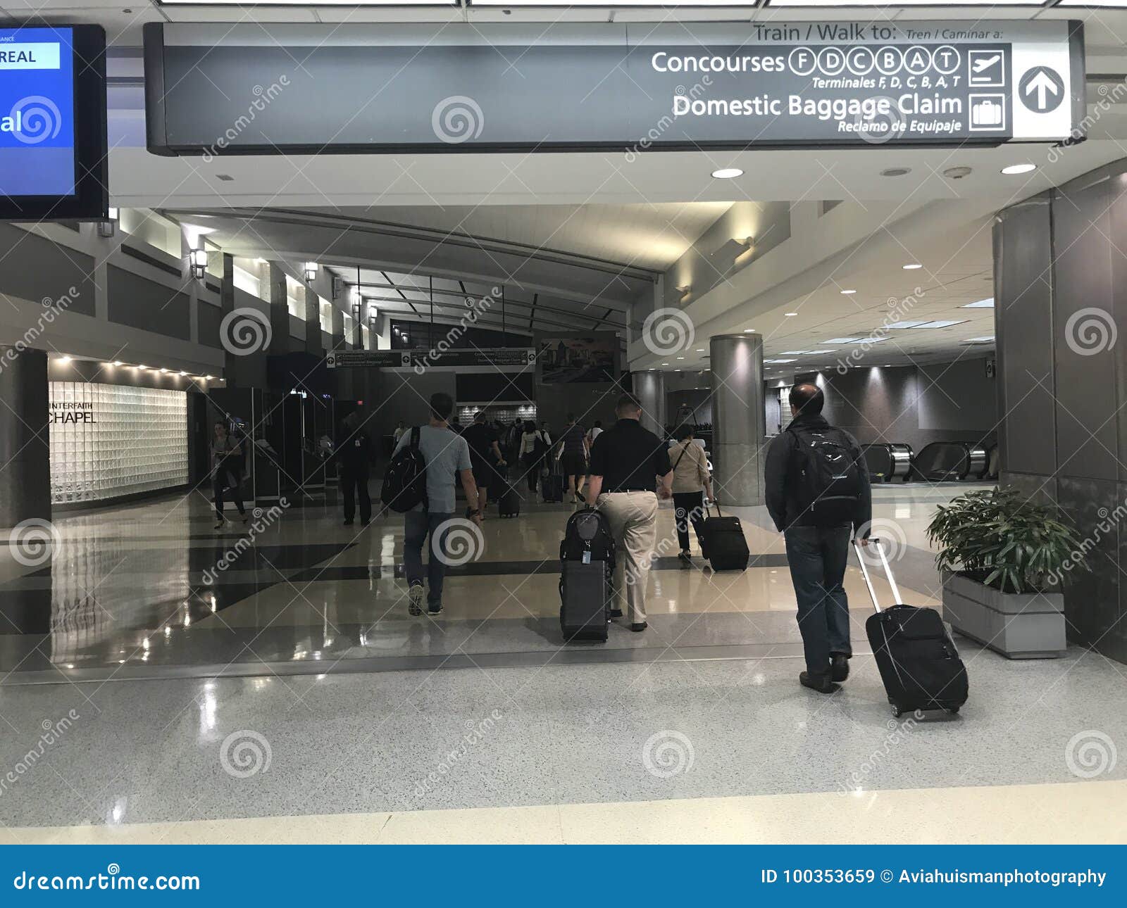 View Of Airport Passengers Heading To Concourses And Baggage