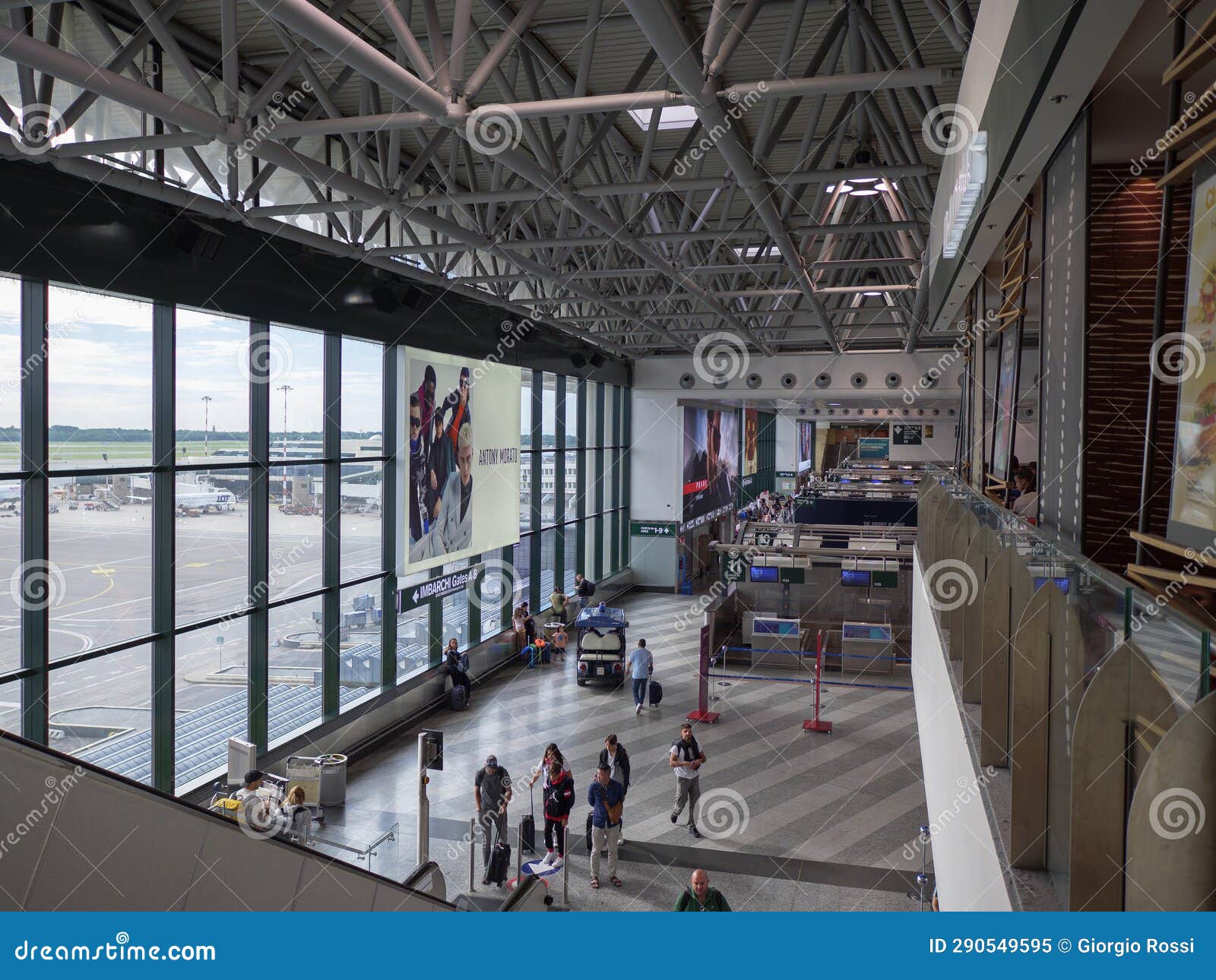 Passengers Inside the Milan Malpensa Airport Facility in Italy