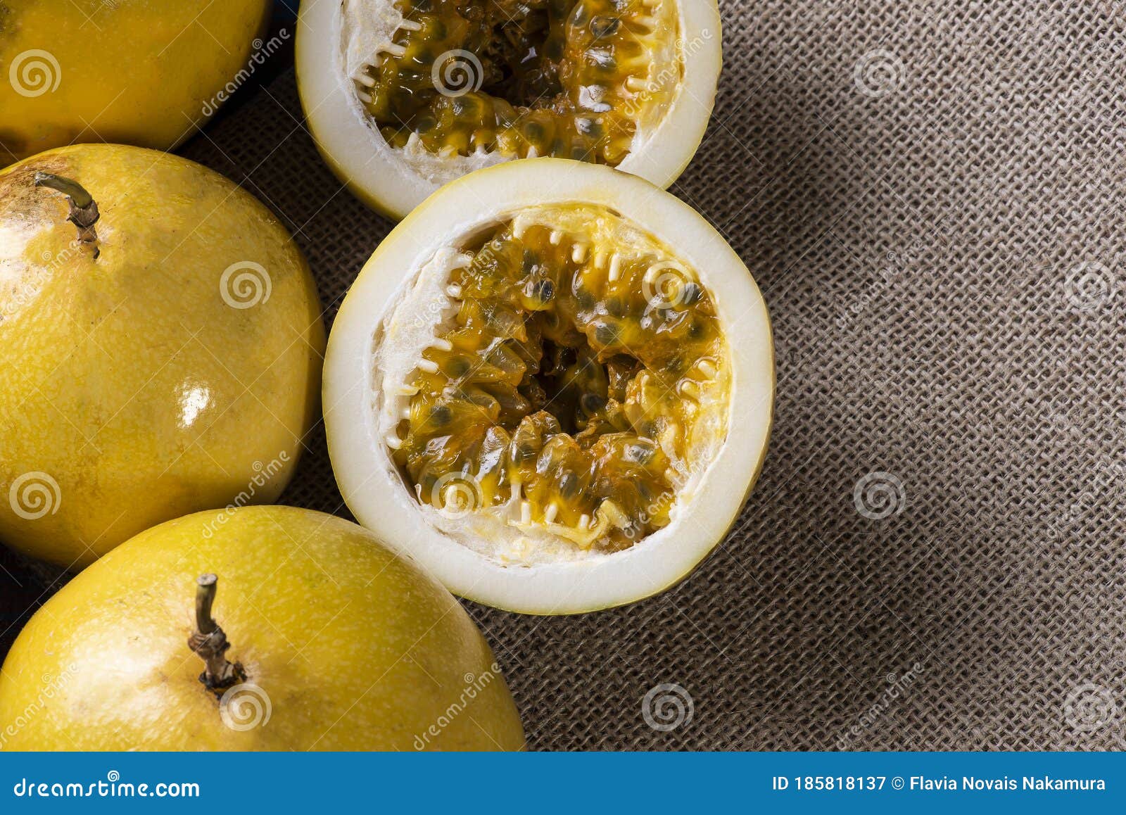 Passion Fruit Cut in Half and Some Whole Passion Fruit. Wood Background