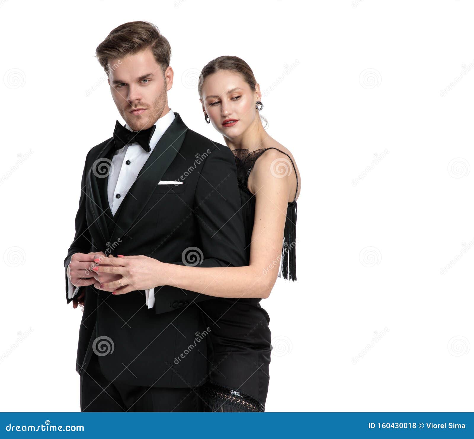 Passionate Girlfriend Embracing His Lover and Looking Away Stock Photo