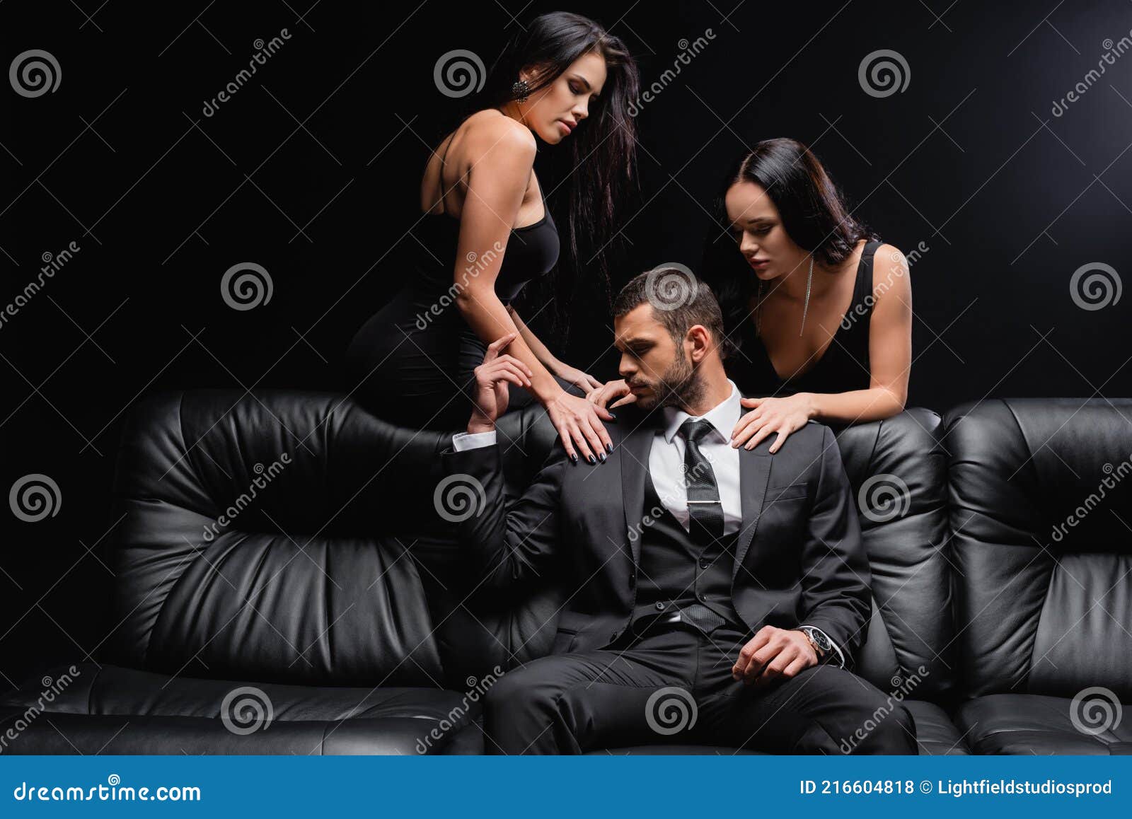 Passionate Women Seducing Man in Suit Stock Photo picture