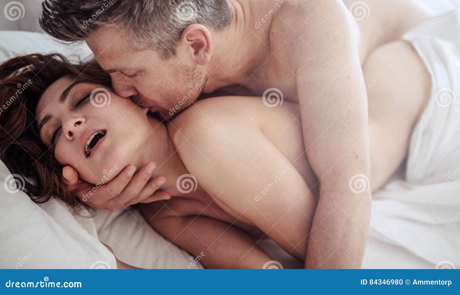 Passionate Young Couple on Bed Having Sex Stock Photo