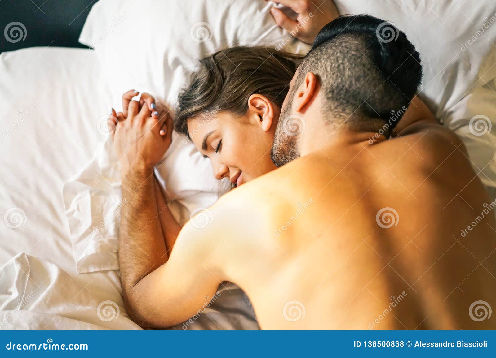 Passionate Young Couple Having Sex on the Bed at Home - Intimate and Sensual Moments of a Couple Making Love in the Bedroom Stock Photo image