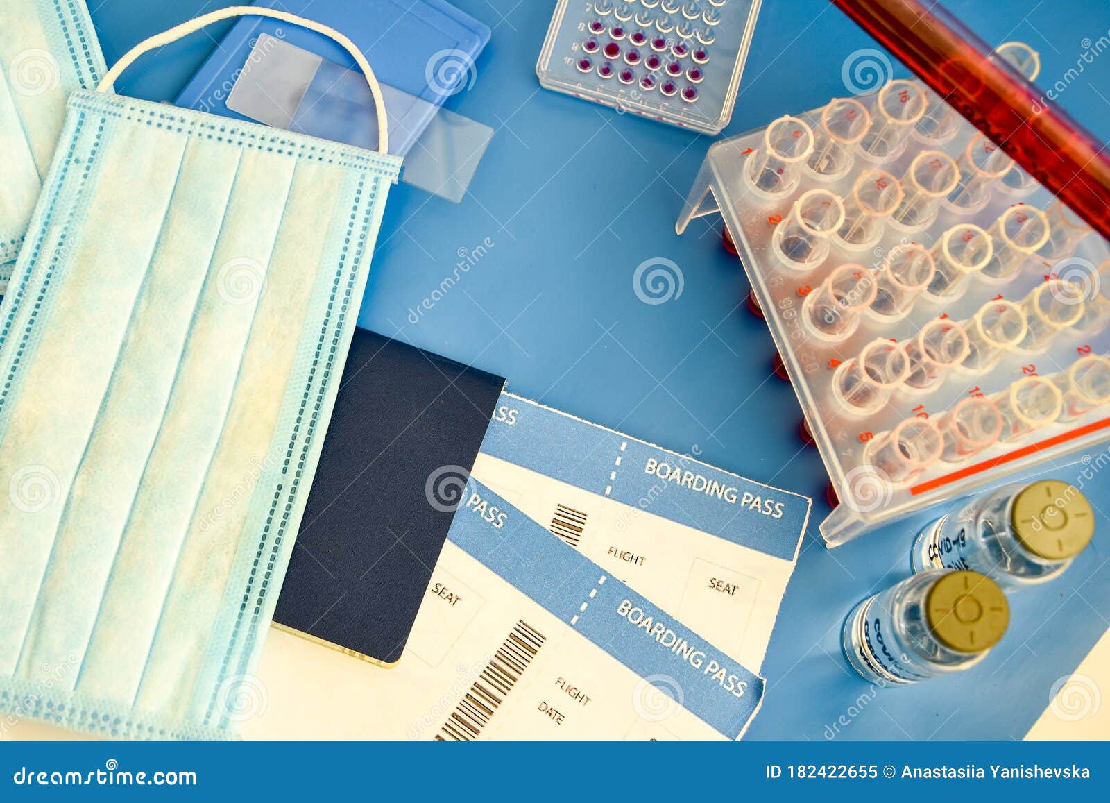 passport with boarding pass and medical surgical mask for protection against coronavirus on a bright blue background. layout for