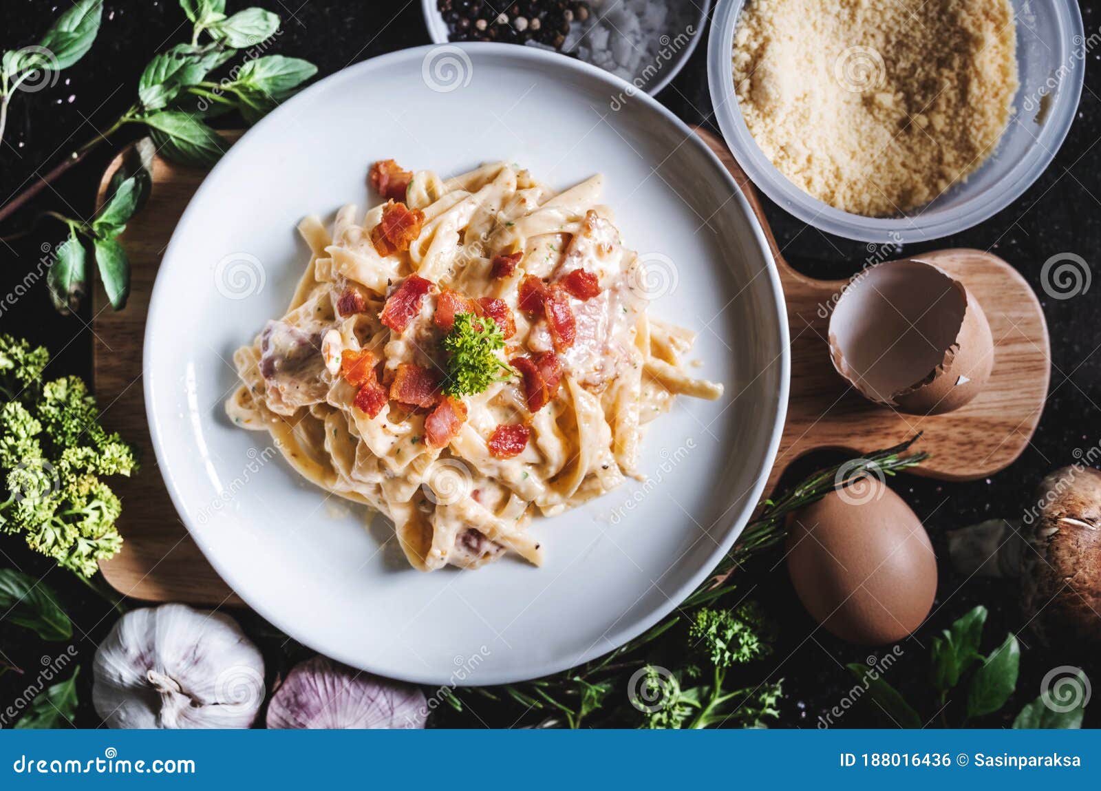 pasta carbonara in white dish, surround fresh ingredient