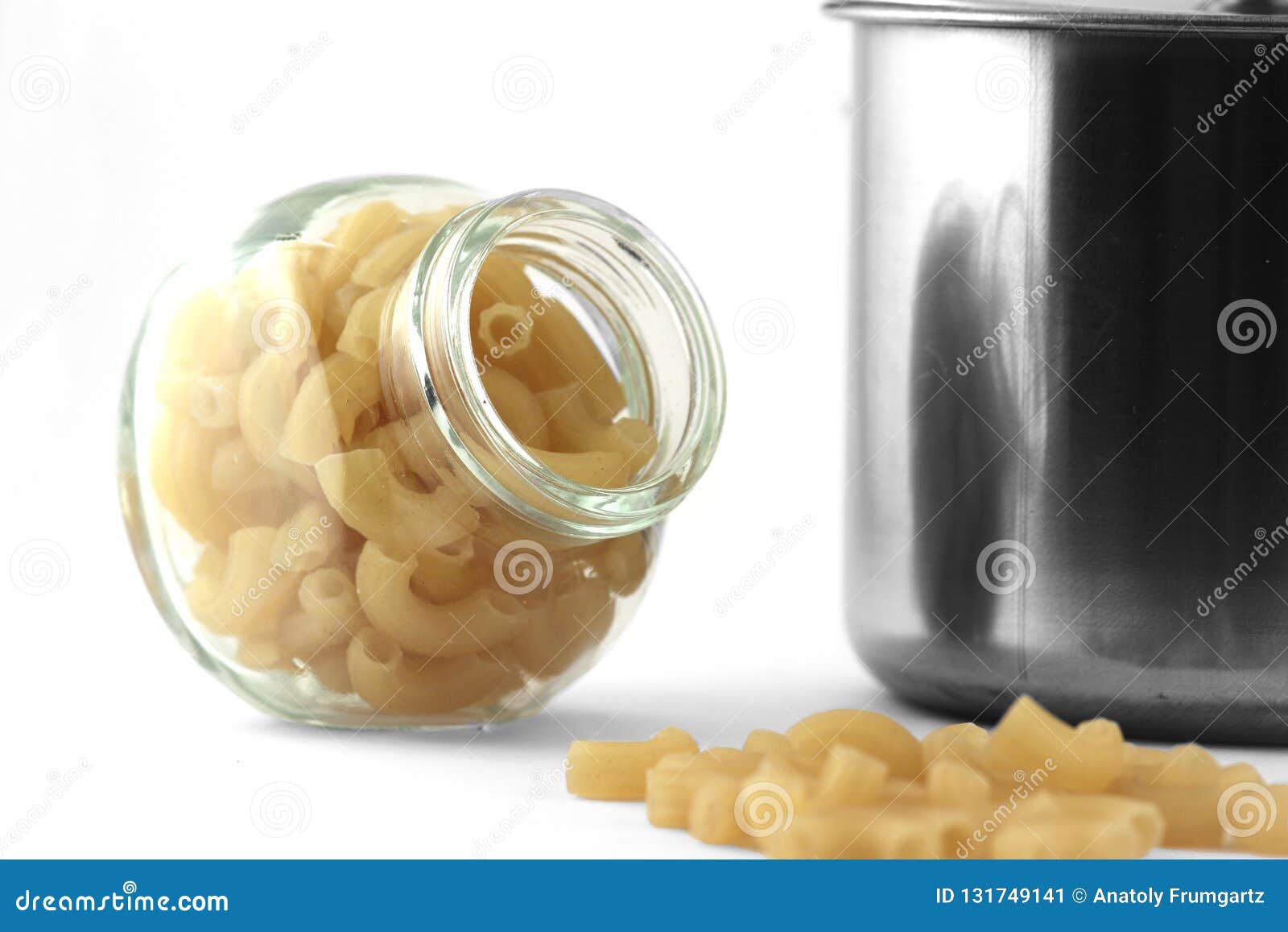 Pasta in the Glass Can and the Saucepan on White Background Stock Image
