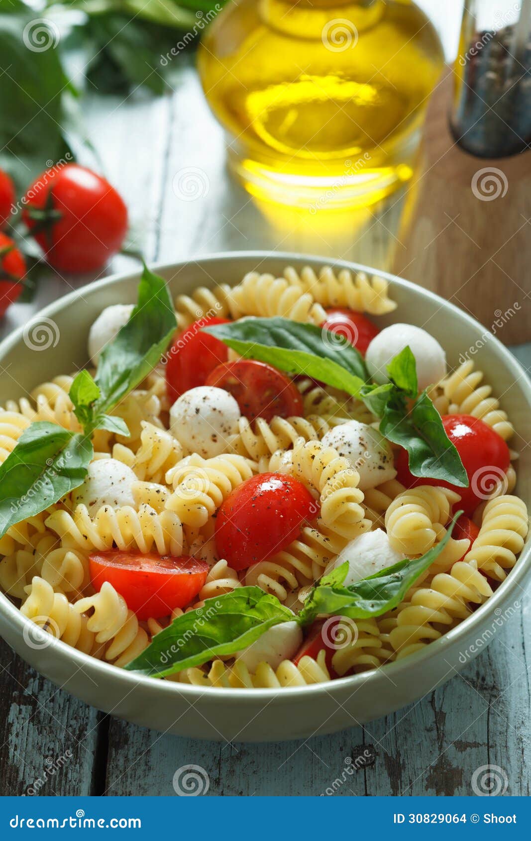 Pasta Salad with Cherry Tomatoes and Basil Leaves Stock Photo Image